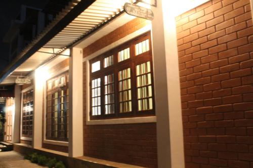 a brick building with windows on the side of it at Windy Hanthana in Kandy