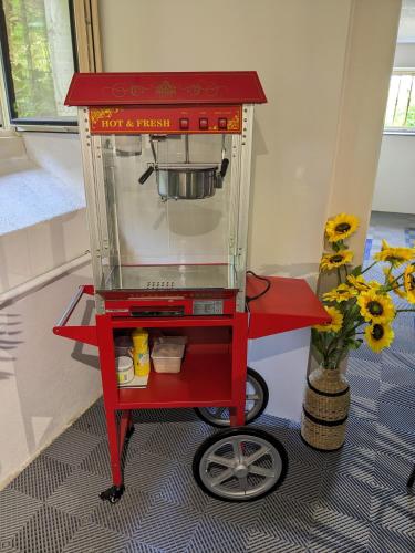 a red food cart with a pot on top at Villa Morton - Domaine du Grand Tourmalet Pic du Midi in Bagnères-de-Bigorre
