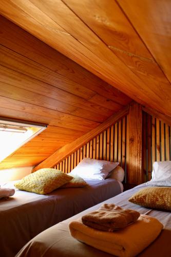 a room with two beds in a wooden room at Casa da Eira in Marco de Canaveses