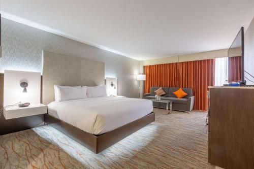 a large hotel room with a bed and a television at DoubleTree by Hilton Dallas/Richardson in Richardson