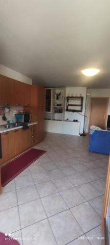a large kitchen with a large white tile floor at Casa Hena in Croviana