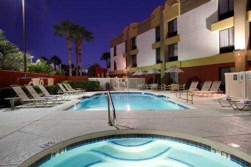 a swimming pool in front of a hotel at night at Hampton Inn Las Vegas/Summerlin in Las Vegas