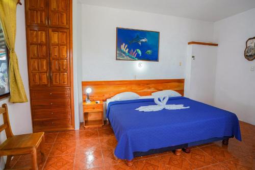 Cama o camas de una habitación en Galapagos Verde Azul