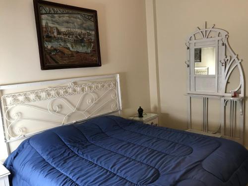 a bedroom with a blue bed and a mirror at The Wall Montevideo [ 105 ] Live in the Old Town in Montevideo