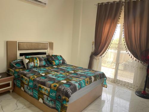 a bedroom with a bed and a window at Vilaria King mariot fully air conditioned villa فيلاريا كنج مريوط فيلا مكيفه بالكامل in Alexandria