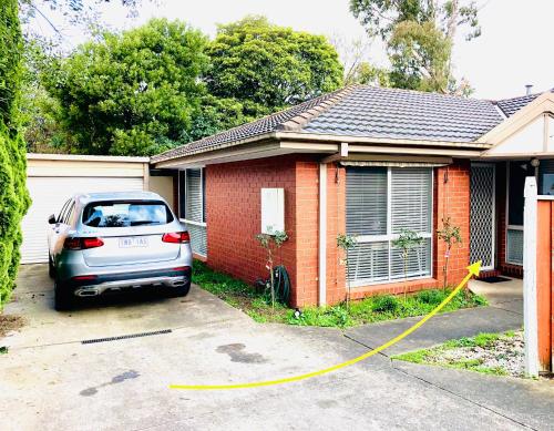 a car parked in front of a house with a yellow hose at PRIVATE ROOM 4 and PRIVATE ROOM 5 beside Monash University in Clayton in Clayton North