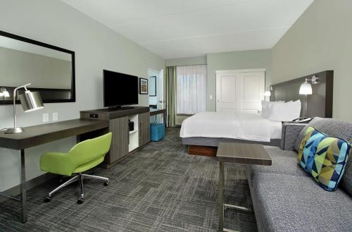 a hotel room with a bed and a desk at Hampton Inn Hagerstown-Maugansville in Hagerstown