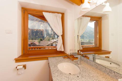 a bathroom with a sink and a window at Lovely apt in Pinzolo Val Rendena 7 in Pinzolo