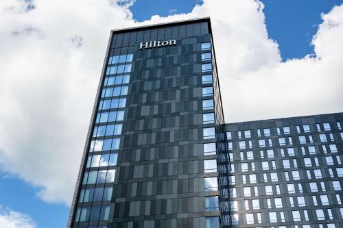 a tall building with the hilton sign on it at Hilton Rochester Mayo Clinic Area in Rochester