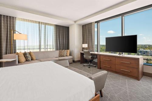 a hotel room with a bed and a flat screen tv at Hilton Rochester Mayo Clinic Area in Rochester