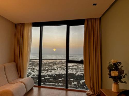 a living room with a view of the ocean at Les Roches De Mazagan in El Jadida