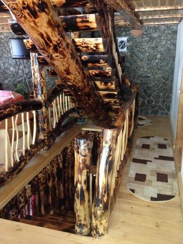 a wooden staircase in a room with a wooden floor at CASA Non Nobis Dambovicioara in Dîmbovicioara