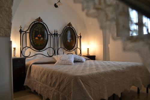 a bedroom with a bed with two mirrors on it at Il Gelso Selvatico in Locorotondo