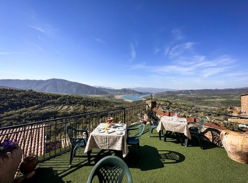 a table and chairs on a balcony with a view at Casa Churchill in Claverol