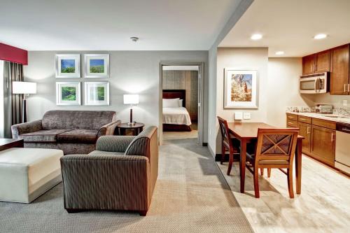 a living room with a couch and a dining room at Homewood Suites by Hilton Bridgewater/Branchburg in Branchburg Park