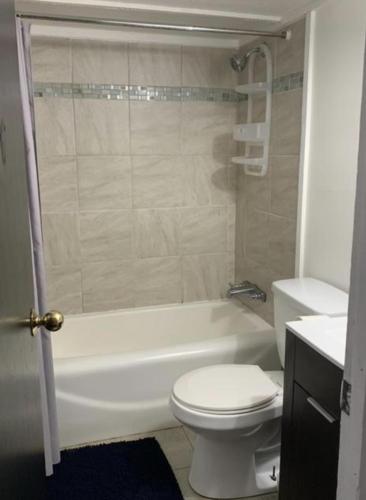 a bathroom with a toilet and a tub and a sink at The Point RV in Townville