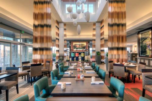 a dining room with long tables and chairs at Hilton Garden Inn Livermore in Livermore