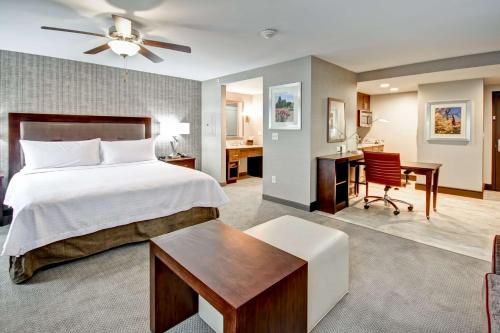 a hotel room with a bed and a desk and a desk at Homewood Suites by Hilton Bridgewater/Branchburg in Branchburg Park
