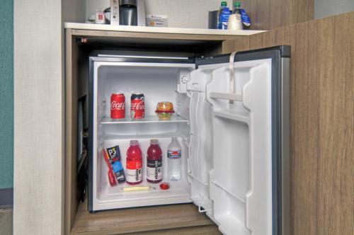 an open refrigerator with coca cola bottles in it at Hilton Garden Inn Livermore in Livermore