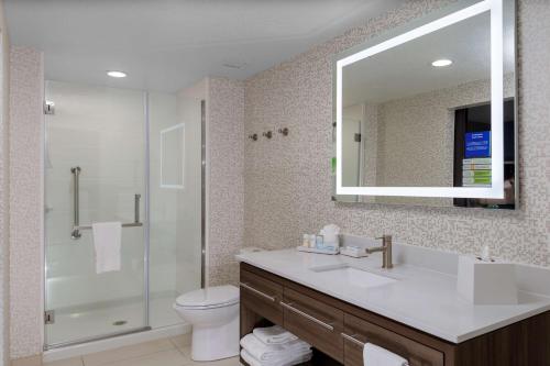 a bathroom with a sink and a toilet and a mirror at Home2 Suites By Hilton Page Lake Powell in Page