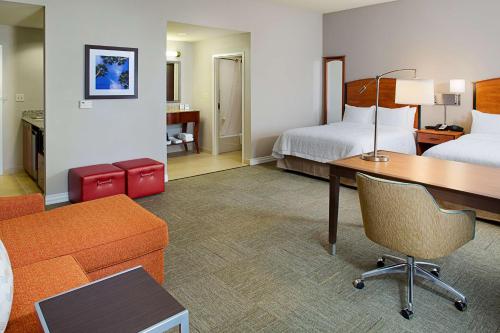 a hotel room with a desk and a bed at Hampton Inn & Suites Lancaster in Lancaster