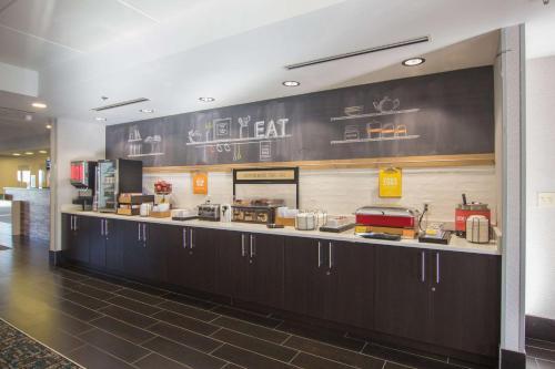 a kitchen with a long counter in a restaurant at Hampton Inn Medina in Medina