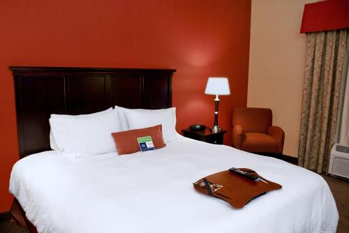 a hotel room with a bed with a brown tray on it at Hampton Inn Las Vegas/North Speedway in Las Vegas