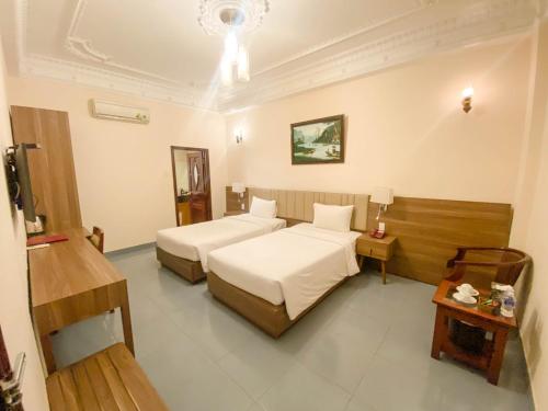 Postel nebo postele na pokoji v ubytování Bon Ami Hotel - Thiên Xuân Hotel