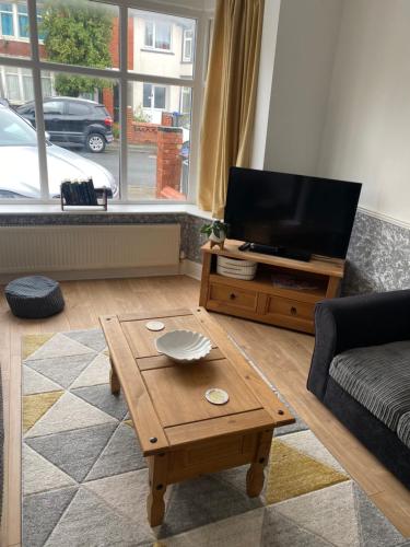 a living room with a television and a coffee table at Richards Retreat Blackpool in Blackpool