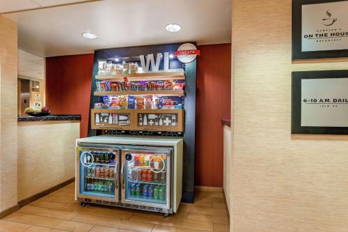 a drink station in a restaurant with a refrigerator at Hampton Inn Milwaukee Airport in Milwaukee