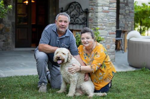 a man and a woman posing with a dog at Birillina Guest House di Laura Reni in Poggio