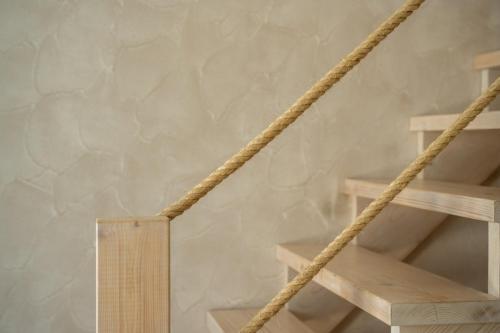 a wooden staircase with a rope next to it at Marla Luxury Residences in Megalokhori