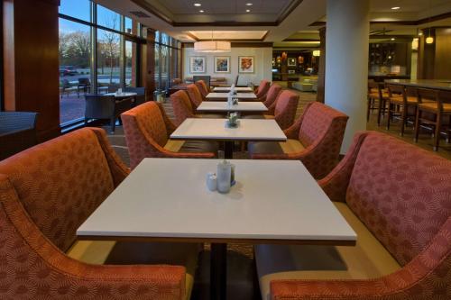 a row of tables and chairs in a restaurant at Hilton Garden Inn Durham-University Medical Center in Durham