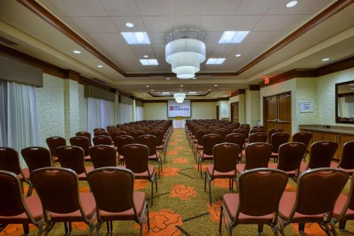 a conference room with chairs and a screen in it at Hilton Garden Inn Durham-University Medical Center in Durham