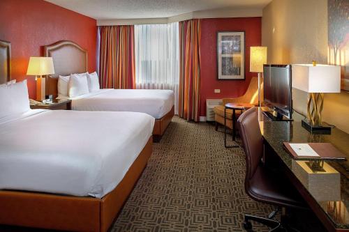 a hotel room with two beds and a television at DoubleTree by Hilton Hotel St. Louis - Chesterfield in Chesterfield