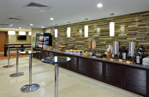 a restaurant with a bar with stools in a room at DoubleTree by Hilton Hotel St. Louis - Chesterfield in Chesterfield
