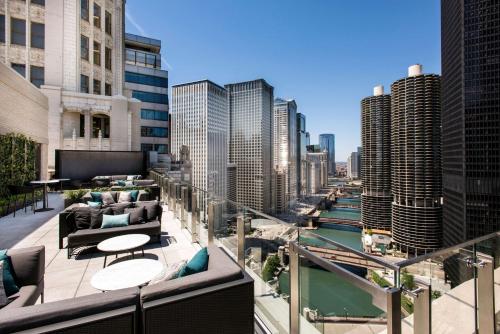 a balcony with a view of a river and buildings at LondonHouse Chicago, Curio Collection by Hilton in Chicago