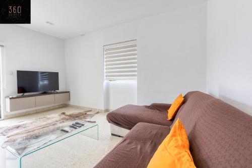 a living room with a couch and a coffee table at Marina VIEW APT SLPs 9 with private terrace & BBQ by 360 Estates in Taʼ Xbiex