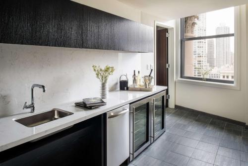 a kitchen with a sink and a counter top at LondonHouse Chicago, Curio Collection by Hilton in Chicago