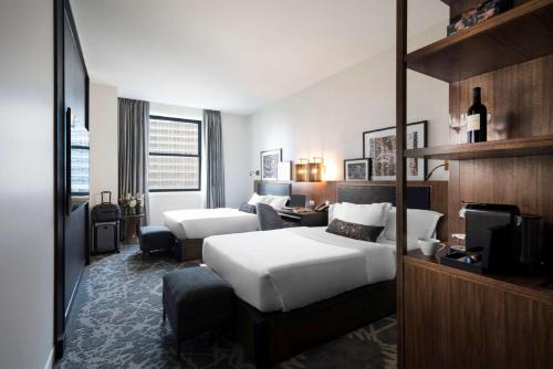 a hotel room with a bed and a couch at LondonHouse Chicago, Curio Collection by Hilton in Chicago