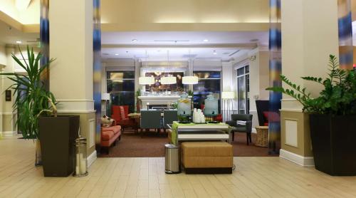 a lobby of a store with chairs and tables at Hilton Garden Inn Secaucus/Meadowlands in Secaucus