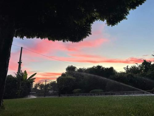 a fire hydrant spraying water in a park with a sky at B&B Villa dei Sogni in Eboli