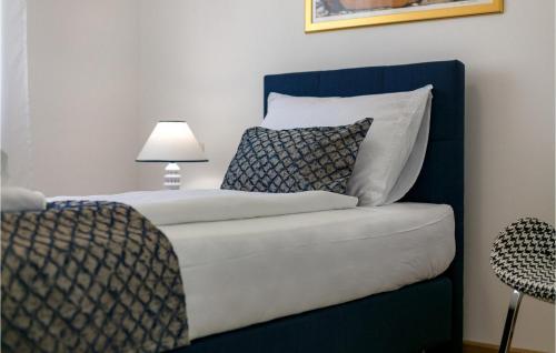 a bedroom with a bed and a couch with a lamp at Villa Makarac in Milna