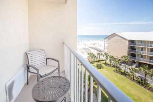 a balcony with a chair and a view of the beach at Hilton Garden Inn Orange Beach in Orange Beach