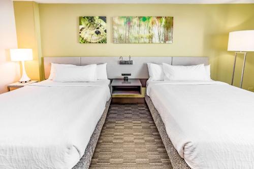 two beds sitting next to each other in a hotel room at Hilton Garden Inn Orange Beach in Orange Beach