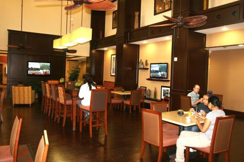 a dining room with people sitting at tables in a restaurant at Hampton Inn & Suites New Braunfels in New Braunfels