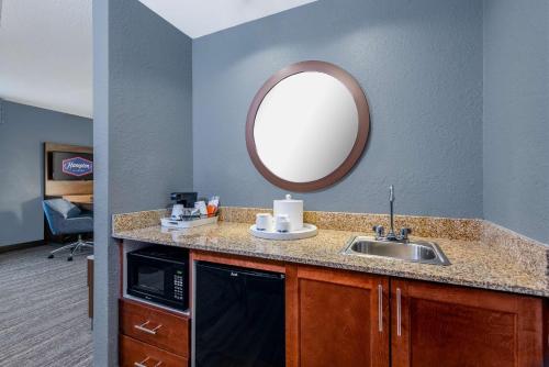 a bathroom with a sink and a mirror at Hampton Inn & Suites Hopkinsville in Hopkinsville