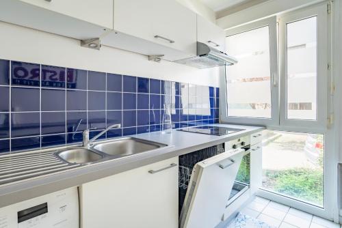 une cuisine avec un évier et une fenêtre dans l'établissement Le Schiffslitt - Hyper-Centre, Proche des Quais, à Strasbourg