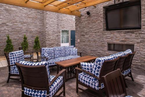 a patio with chairs and a table and a tv at Hampton Inn Benson in Benson