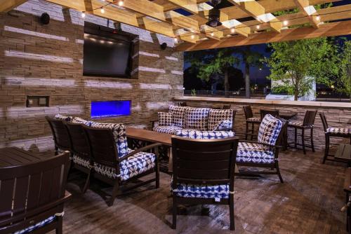 a patio with a table and chairs and a tv at Hampton Inn Benson in Benson